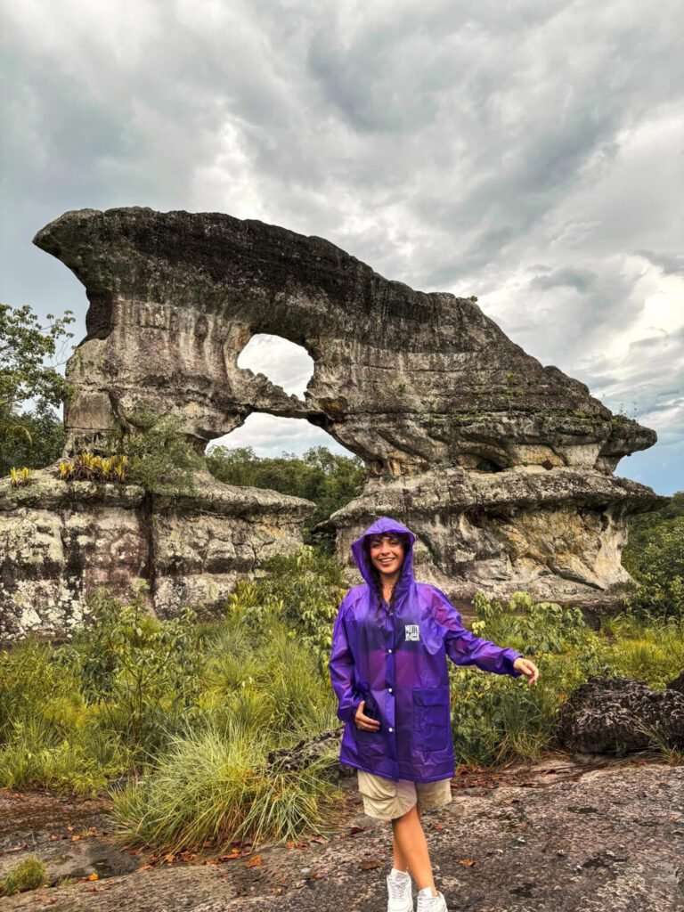 Woman standing in front of the Gate of Orion, a mystical rock formation in Guaviare, Colombia