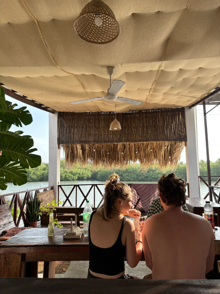 Couple dining at open air restaurant overlooking mangroves in Rincón del Mar, Colombia