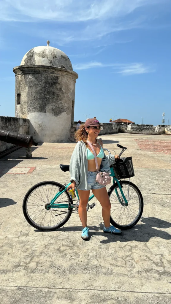 Woman with bicycle at Castillo San Felipe colonial fortress in Cartagena, Colombia